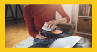 Woman cleaning an LP with a towel