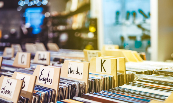 Close-up of LPs in a record store sorted by band alphabetically