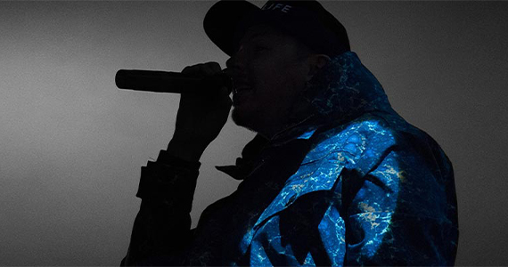Silhouette of a rapper with a baseball cap and microphone