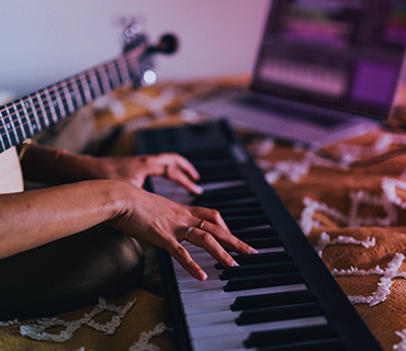 Record music A close-up of hands playing a keyboard