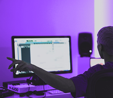 Create your own beats Person looking at a PC screen showing music software