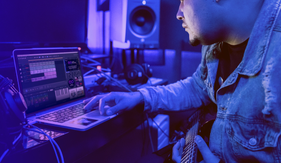 Man in front of laptop with MUSIC MAKER interface